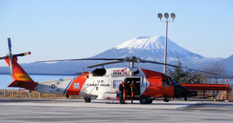 A United States Coast Guard Jayhawk helicopter at Air Station Sitka with Mt. Edgecumbe in the background. 